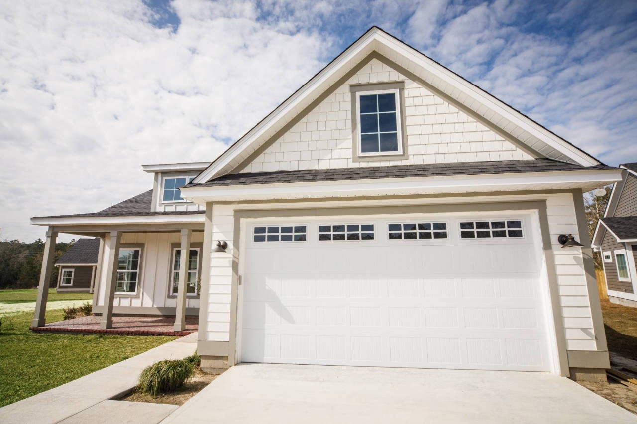 A home with a garage and windows that need blinds at The Shady Lady Interiors near Oklahoma City, OK