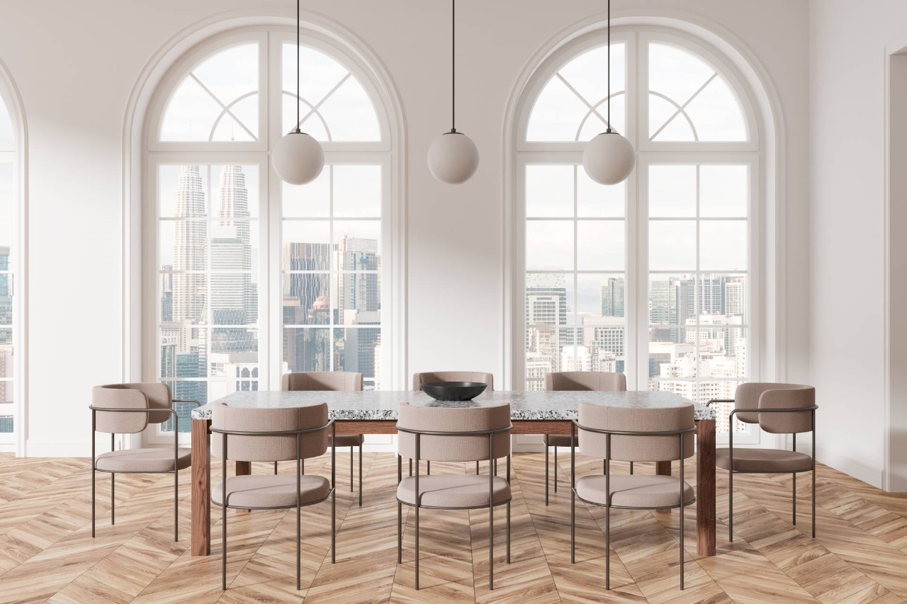 A dining room with large, arched windows at The Shady Lady Interiors near Oklahoma City, OK